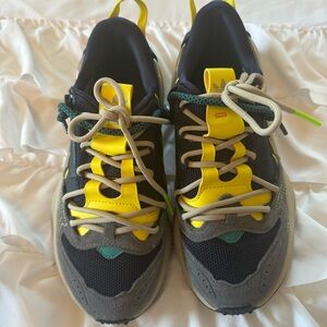 Navy and yellow Adidas sneakers